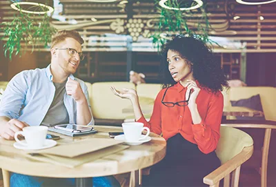 woman and man conversation at coffee shop